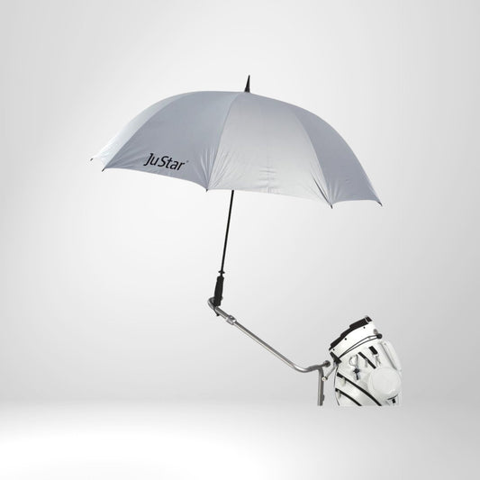Silberner JuStar Golfschirm auf Trolley montiert, Golfbag darunter, vor hellem Hintergrund
