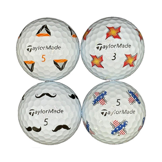 Vier bedruckte TaylorMade Golfbälle mit verschiedenen bunten Motiven auf weißem Hintergrund